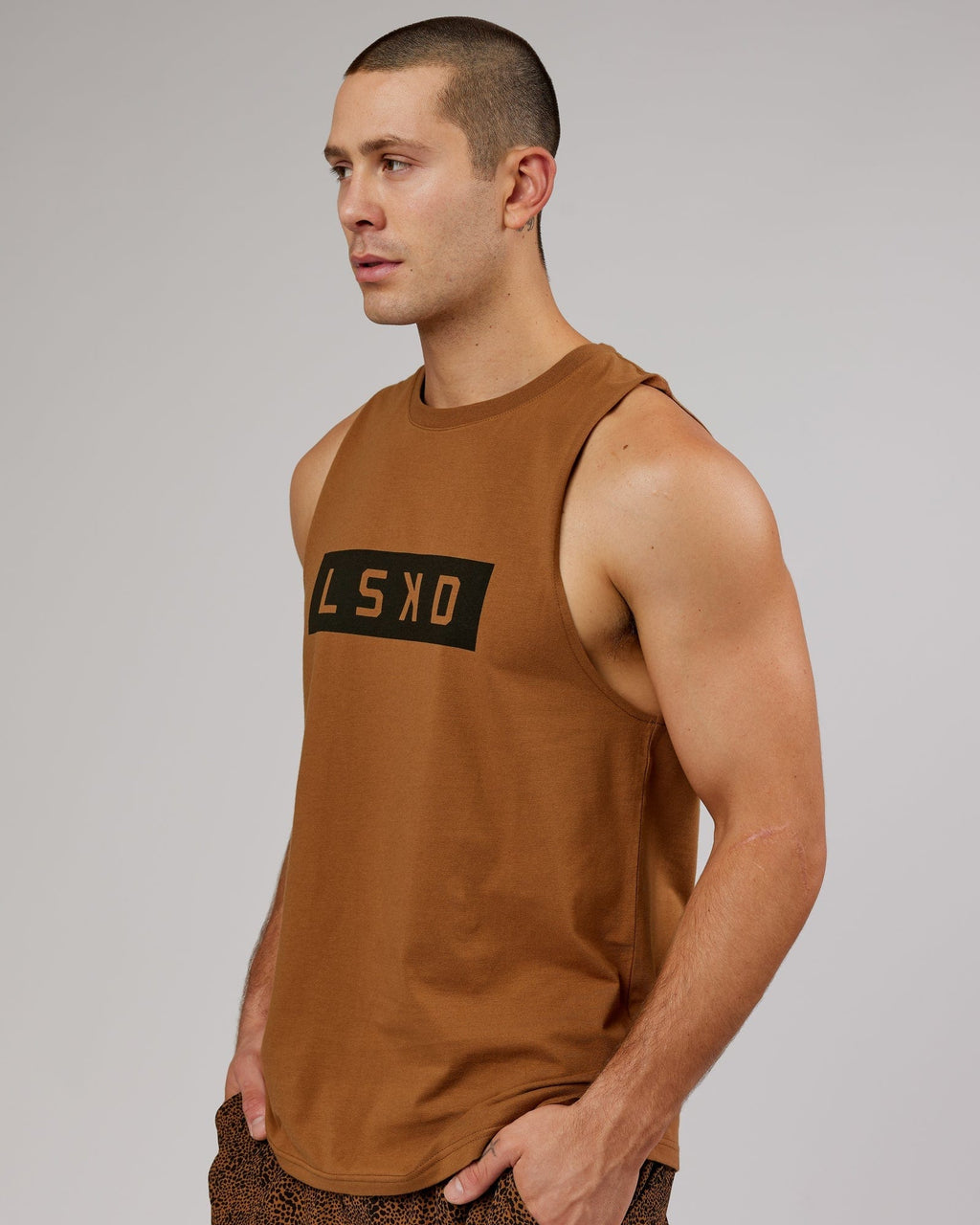 Model wearing Strength FLXDRY Training Fit Performance Tank - Camel