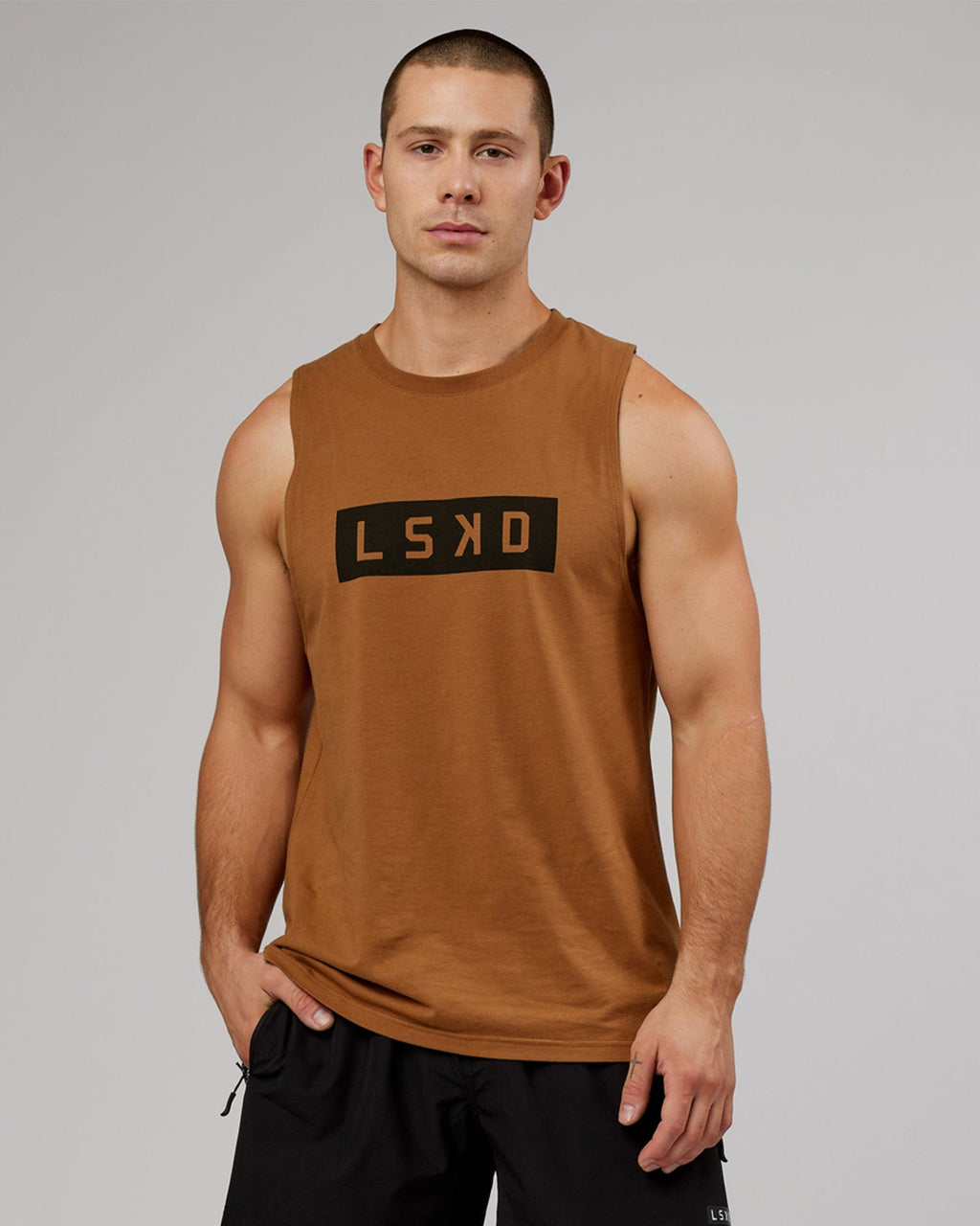 Model wearing Strength FLXDRY Training Fit Performance Tank - Camel