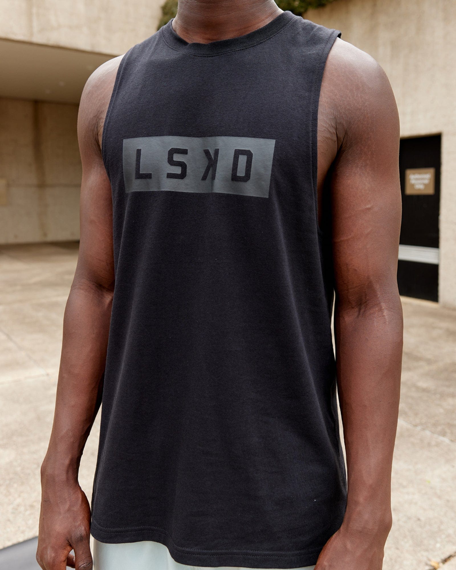 Model wearing Strength FLXDRY Training Fit Performance Tank - Black