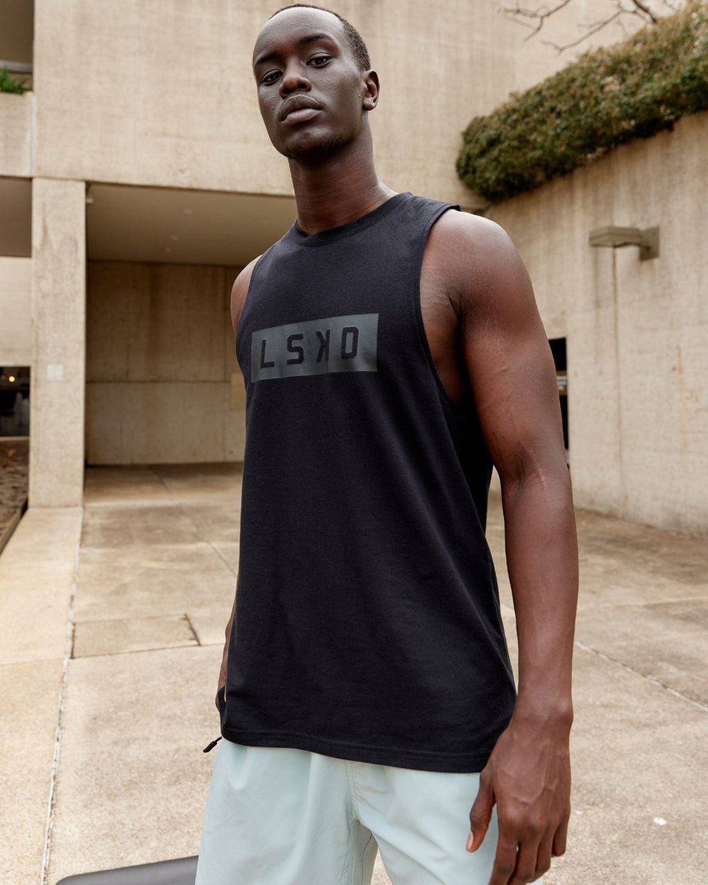 Model wearing Strength FLXDRY Training Fit Performance Tank - Black