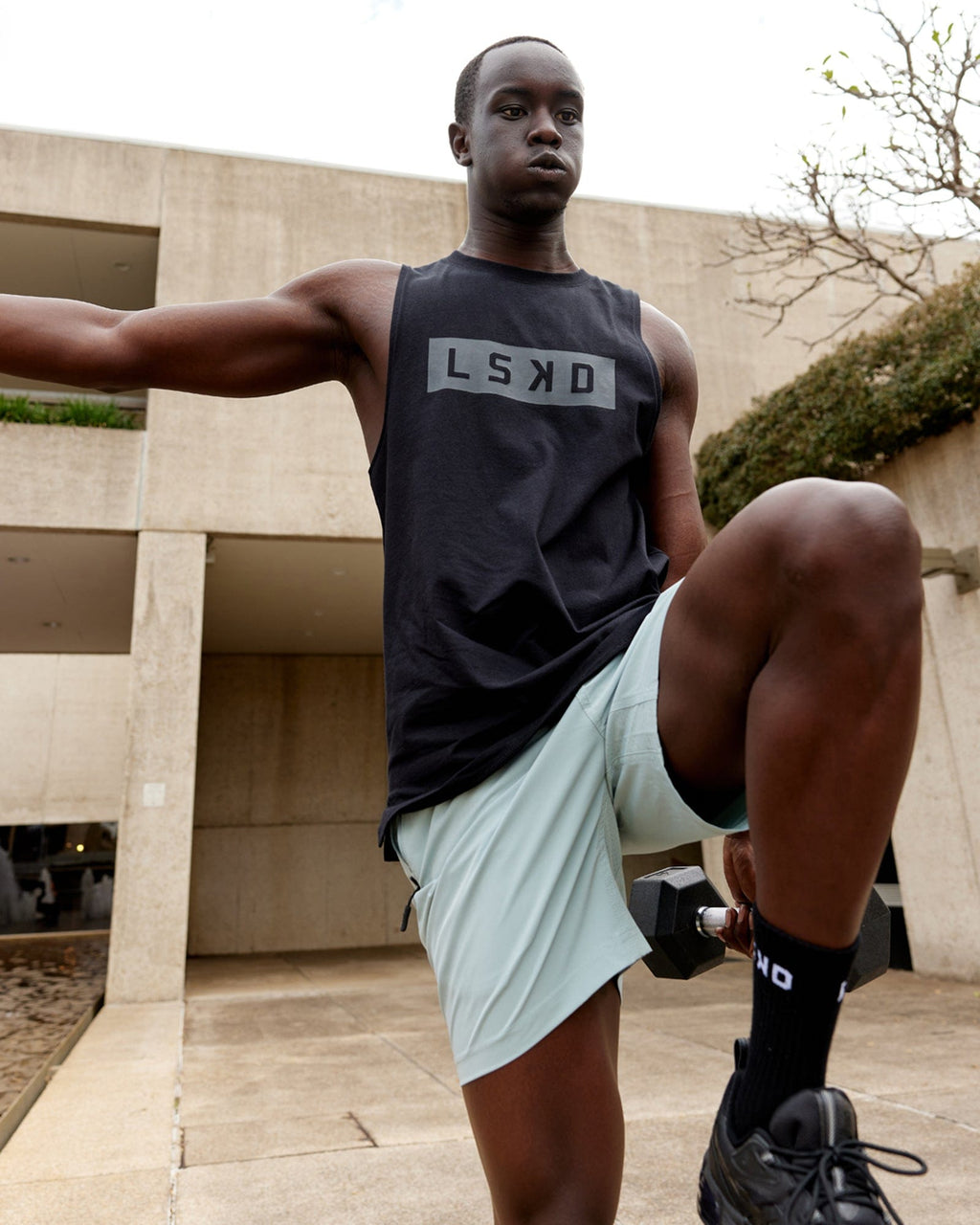 Model wearing Strength FLXDRY Training Fit Performance Tank - Black