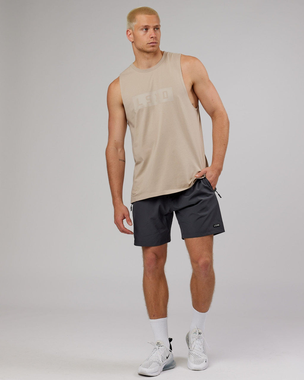 Model wearing Strength FLXDRY Training Fit Performance Tank - Taupe