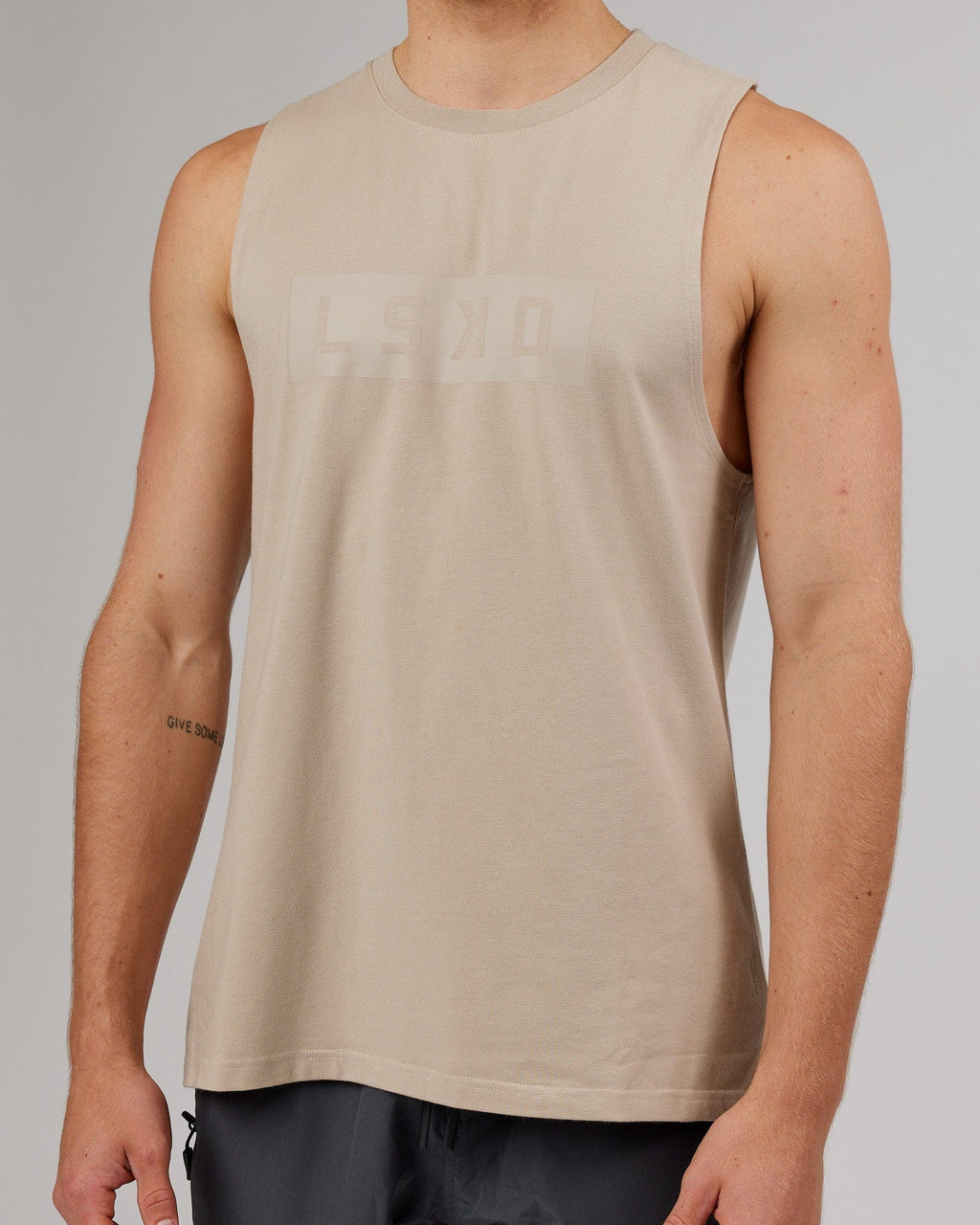 Model wearing Strength FLXDRY Training Fit Performance Tank - Taupe