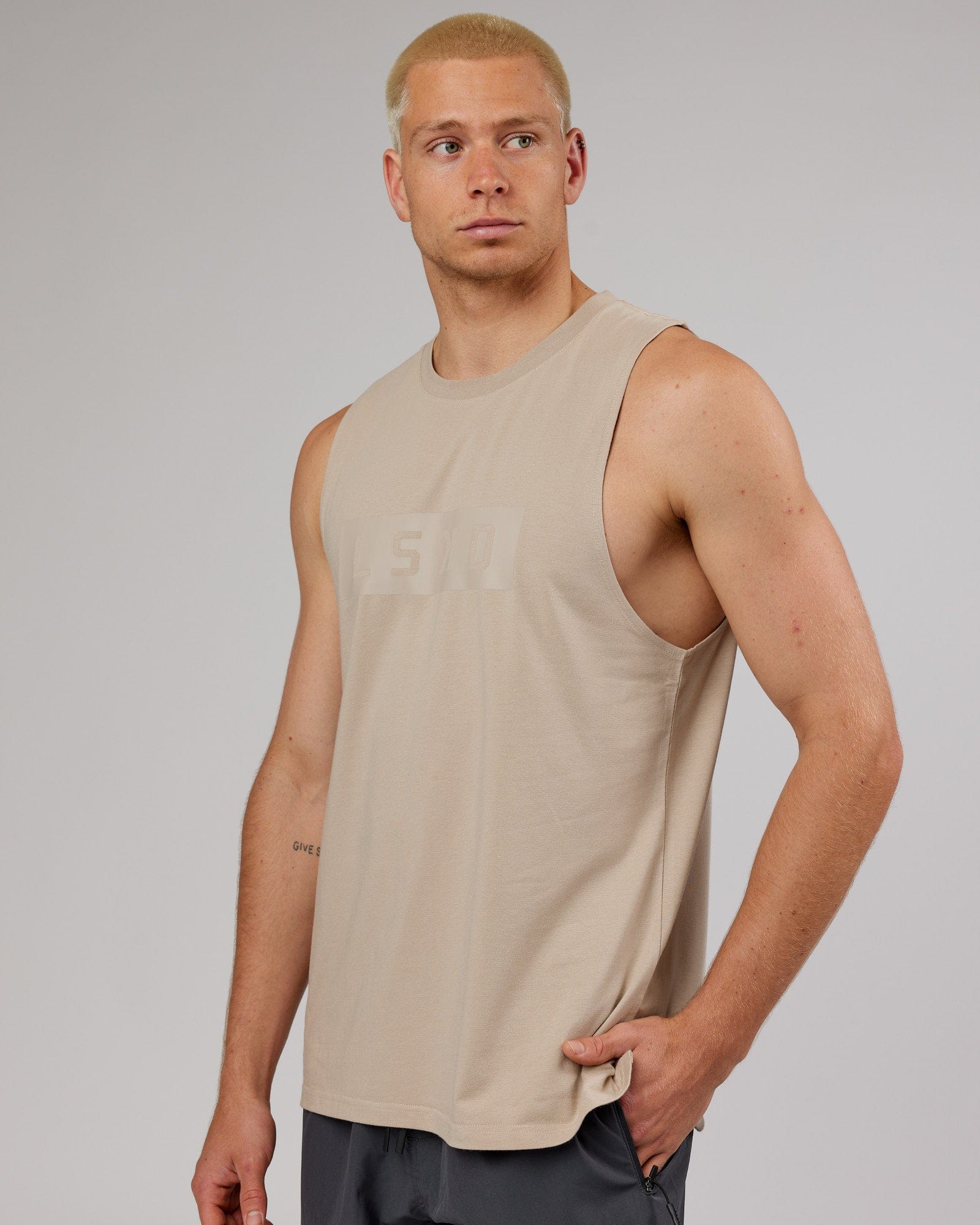 Model wearing Strength FLXDRY Training Fit Performance Tank - Taupe