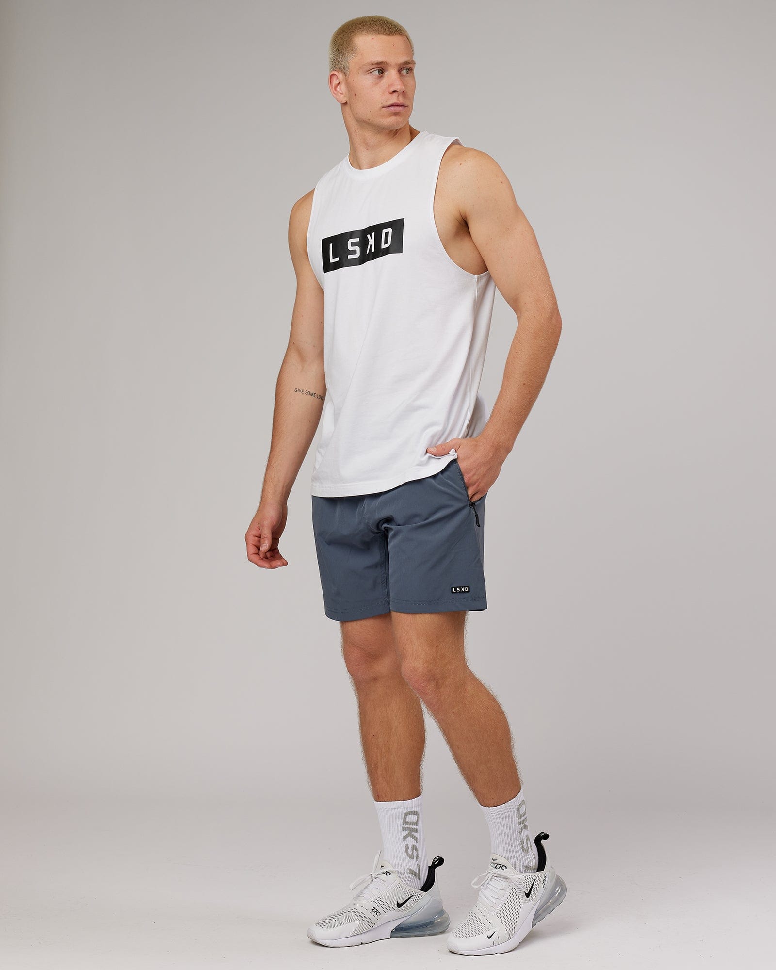 Model wearing Strength FLXDRY Training Fit Performance Tank - White-Black