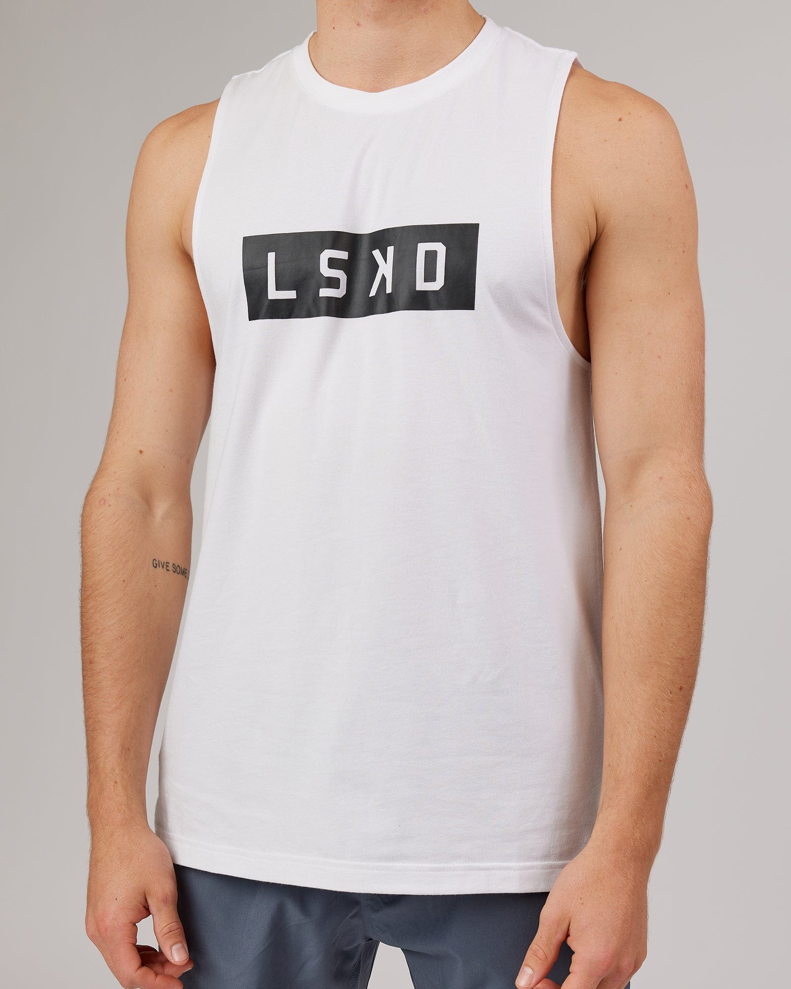 Model wearing Strength FLXDRY Training Fit Performance Tank - White-Black