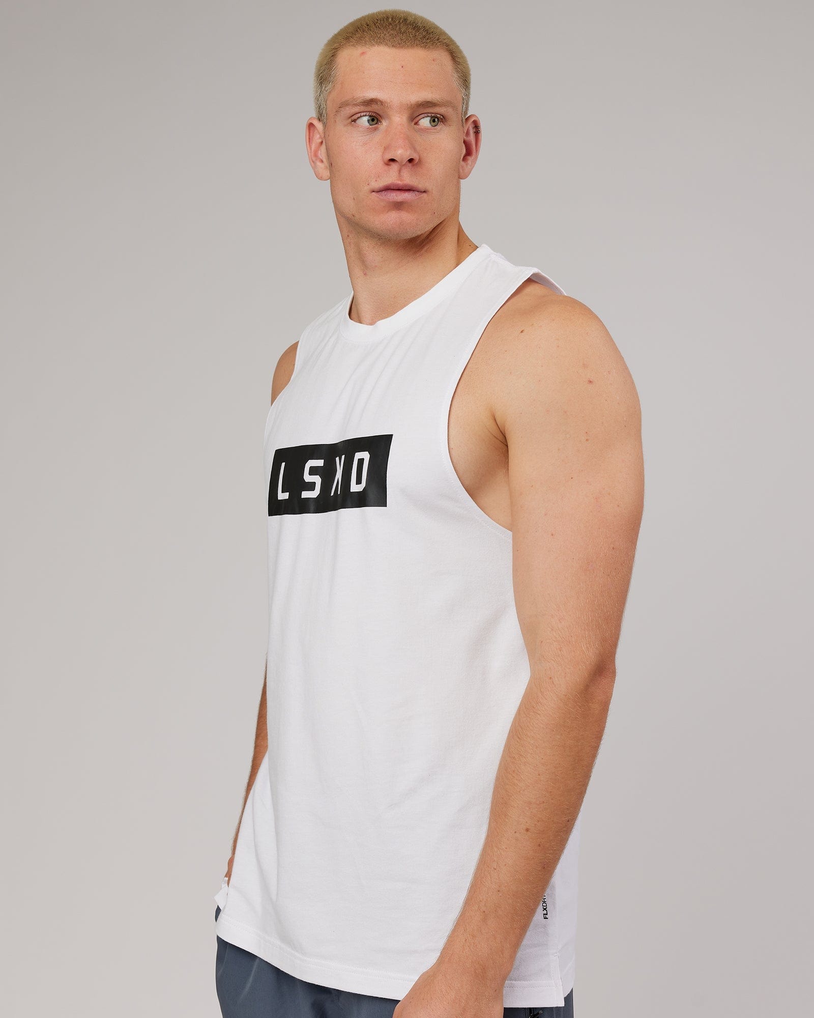 Model wearing Strength FLXDRY Training Fit Performance Tank - White-Black