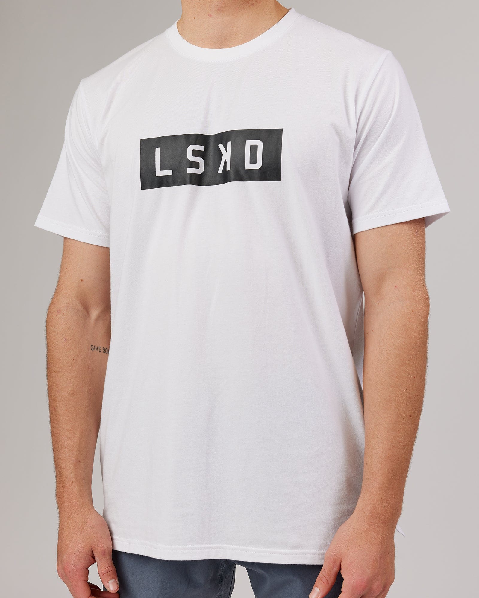 Model wearing Strength FLXDRY Performance Tee - White-Black