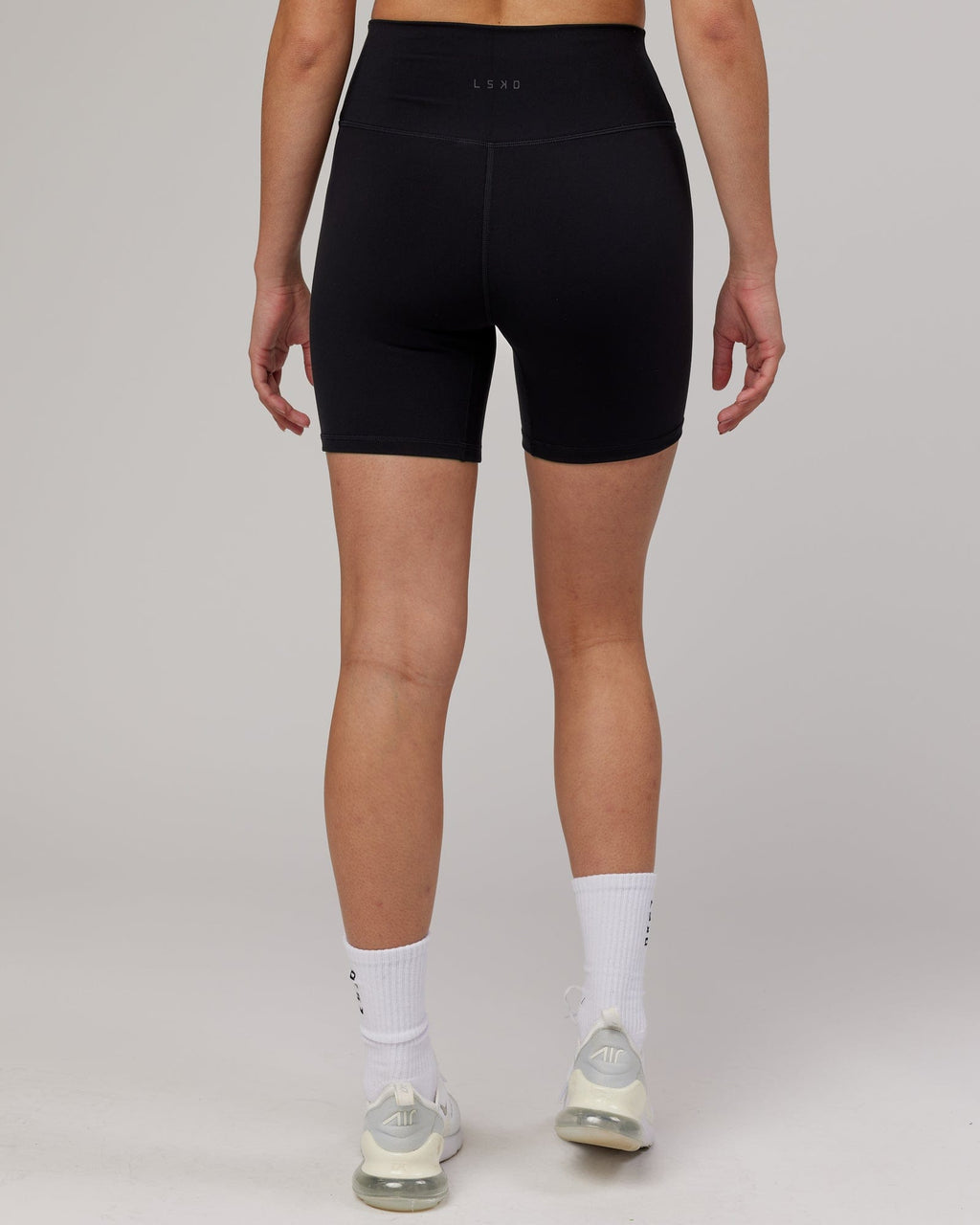 Model wearing Strike Mid Short Tight - Black