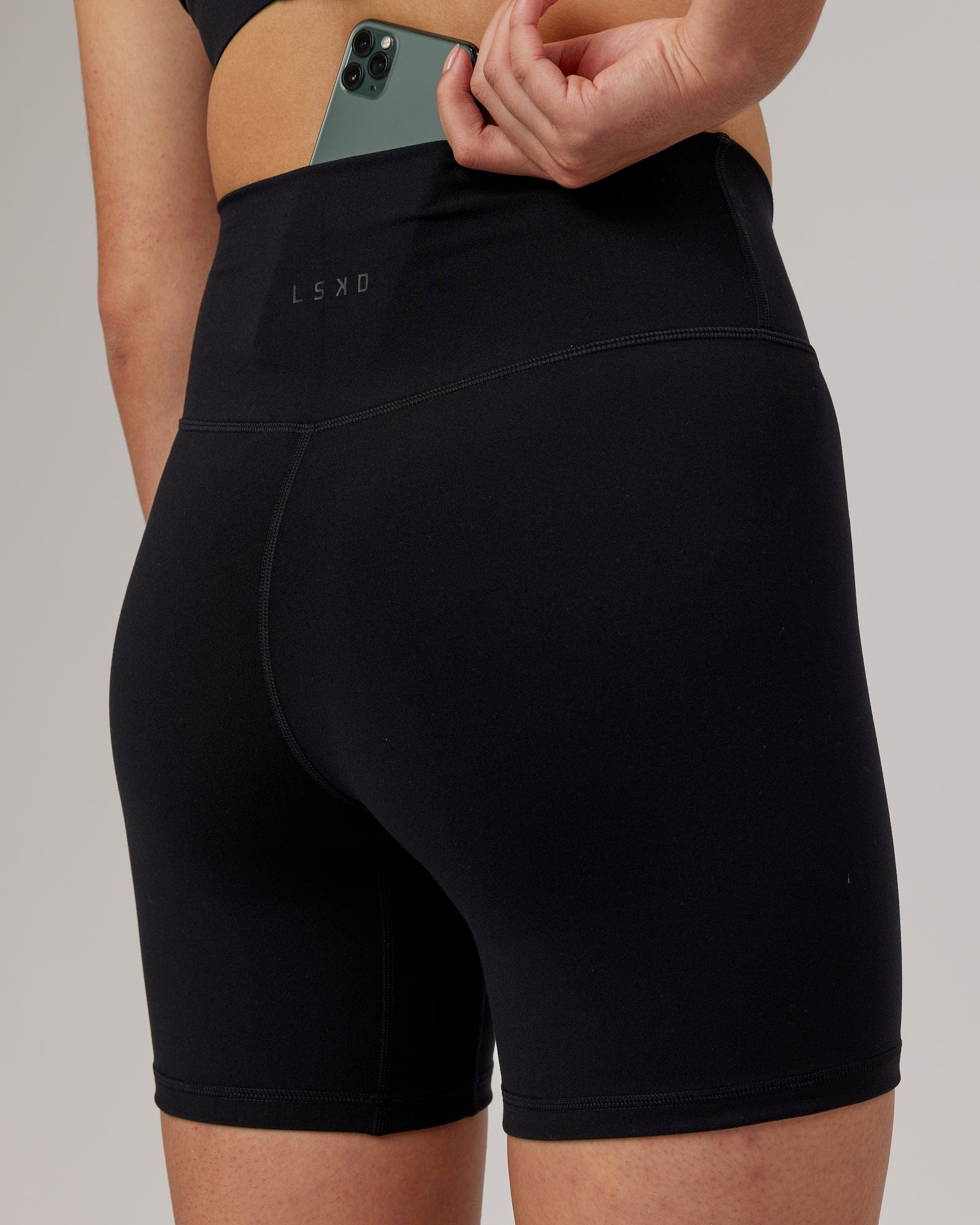 Model wearing Strike Mid Short Tight - Black