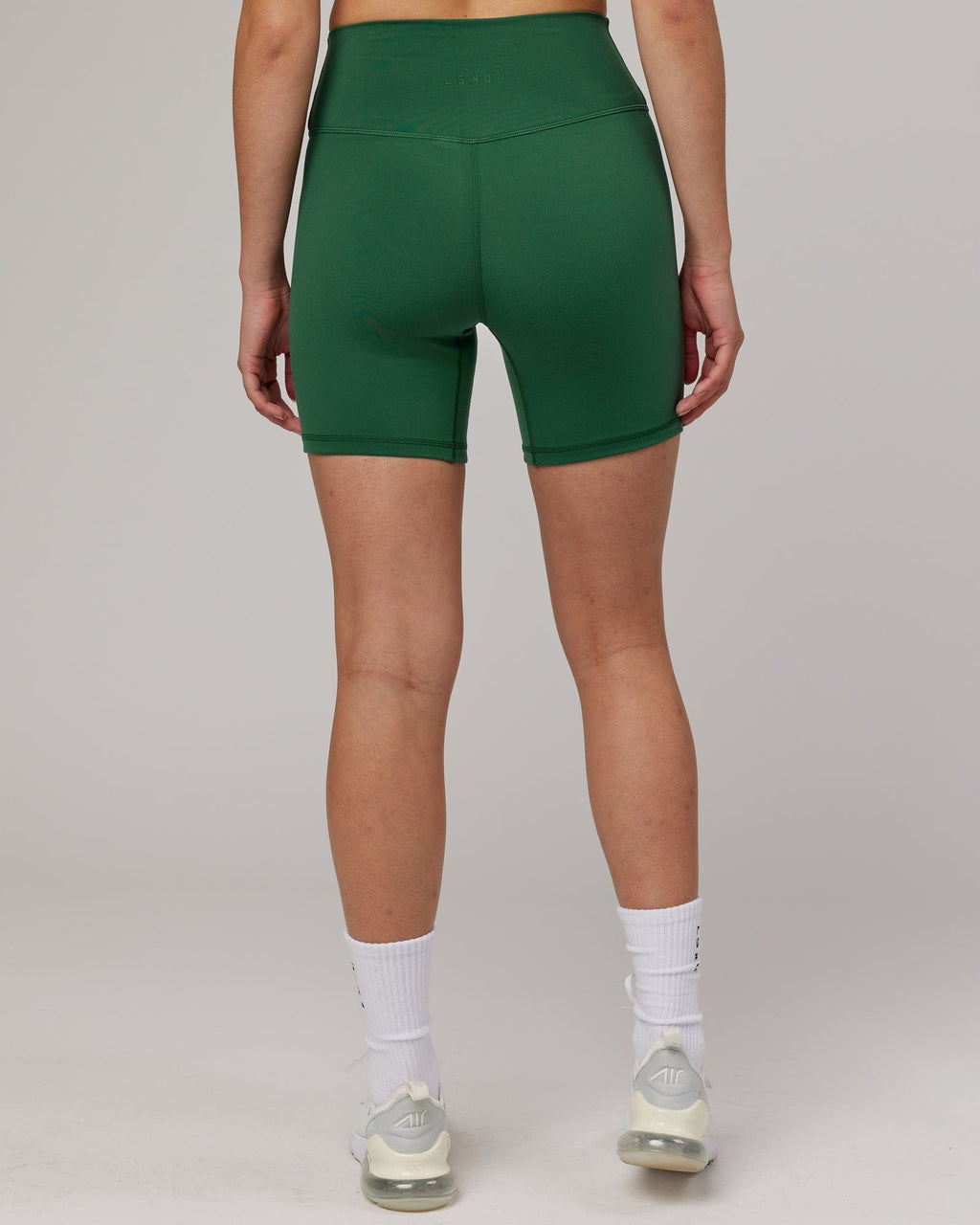 Model wearing Strike Mid Short Tight - Pineneedle