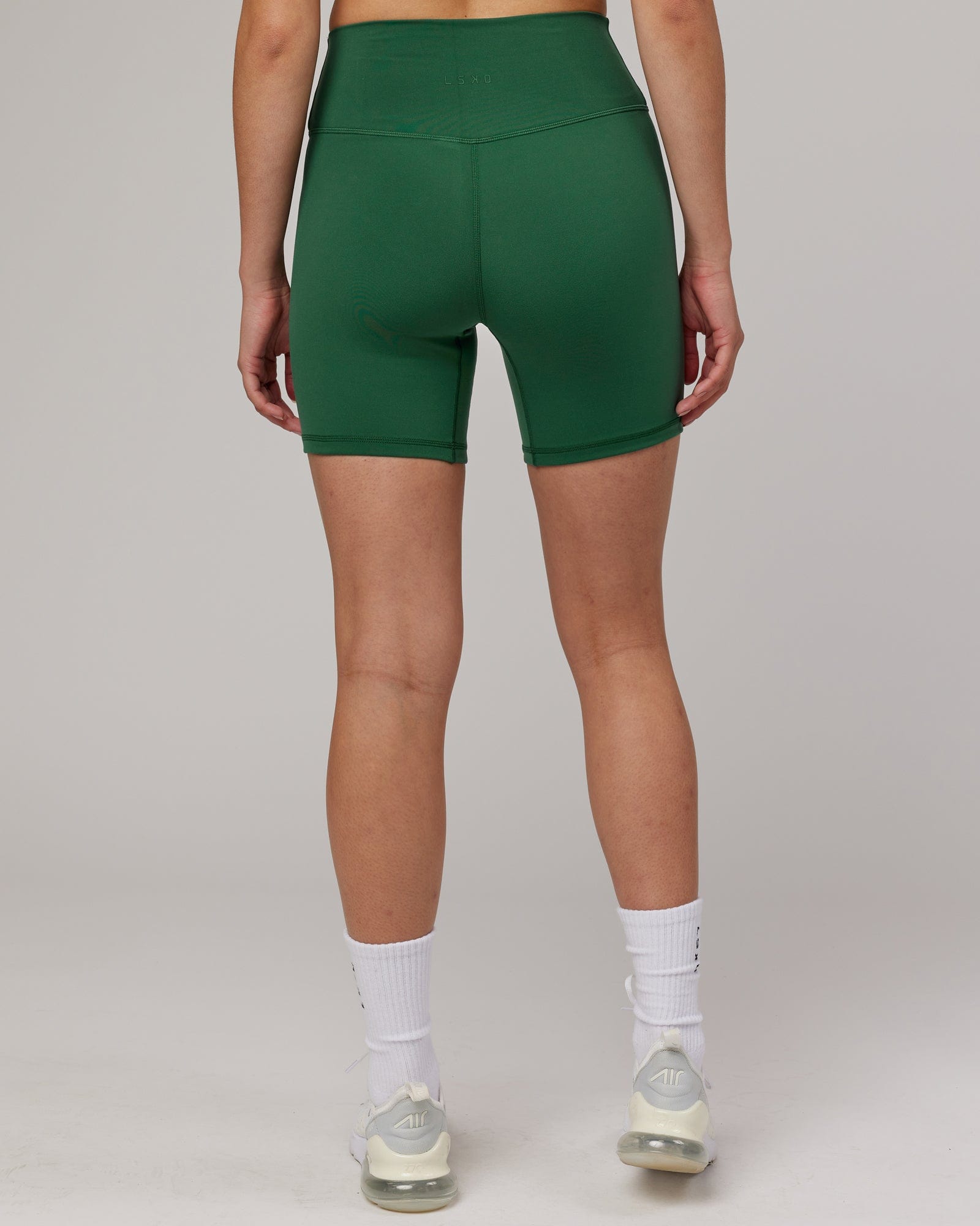 Model wearing Strike Mid Short Tight - Pineneedle