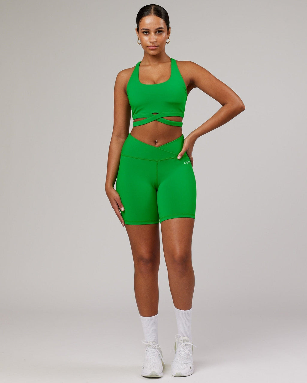 Model wearing Strike Mid Short Tight - Vivid Green