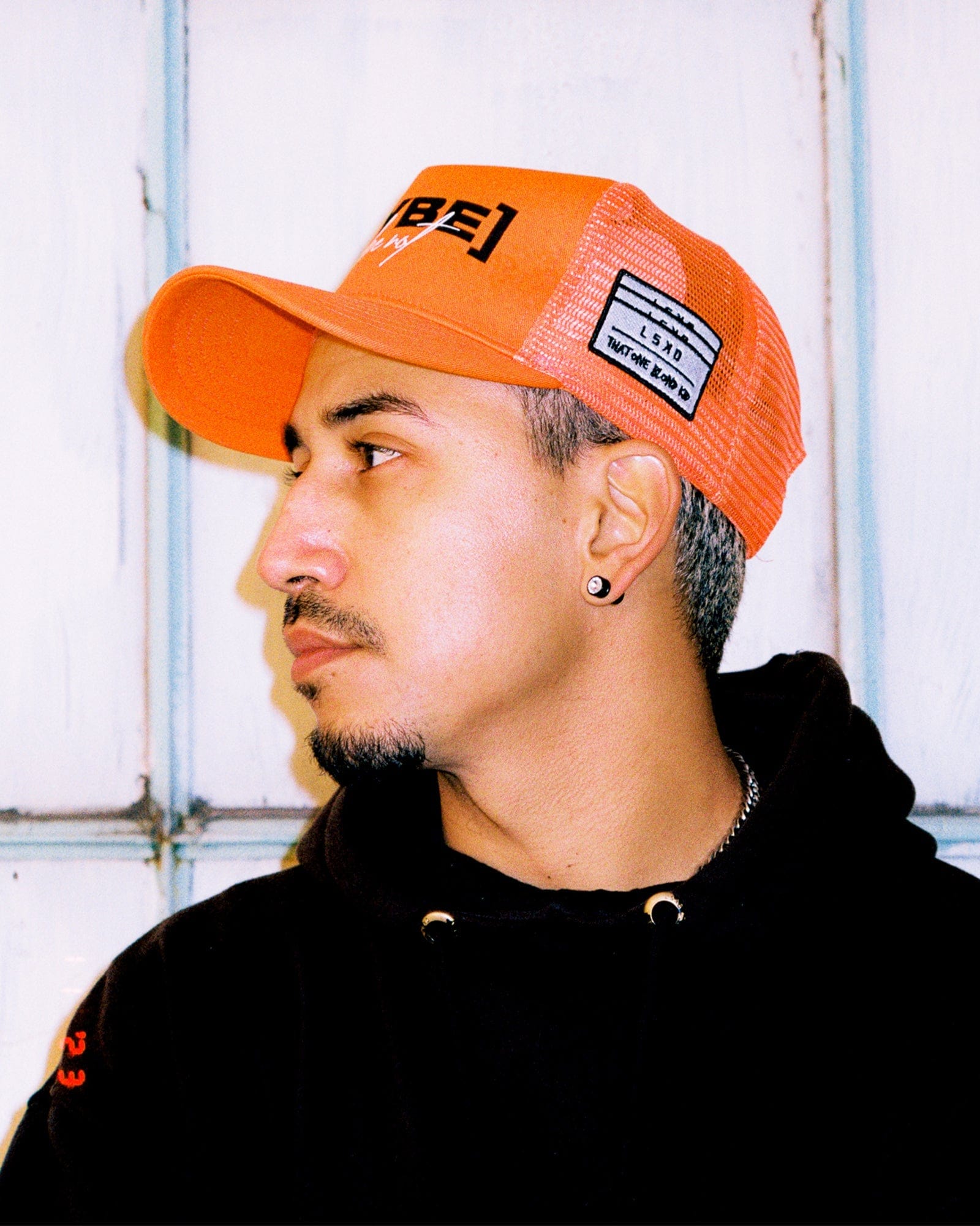 Model wearing TOBK Trucker Hat - Orange