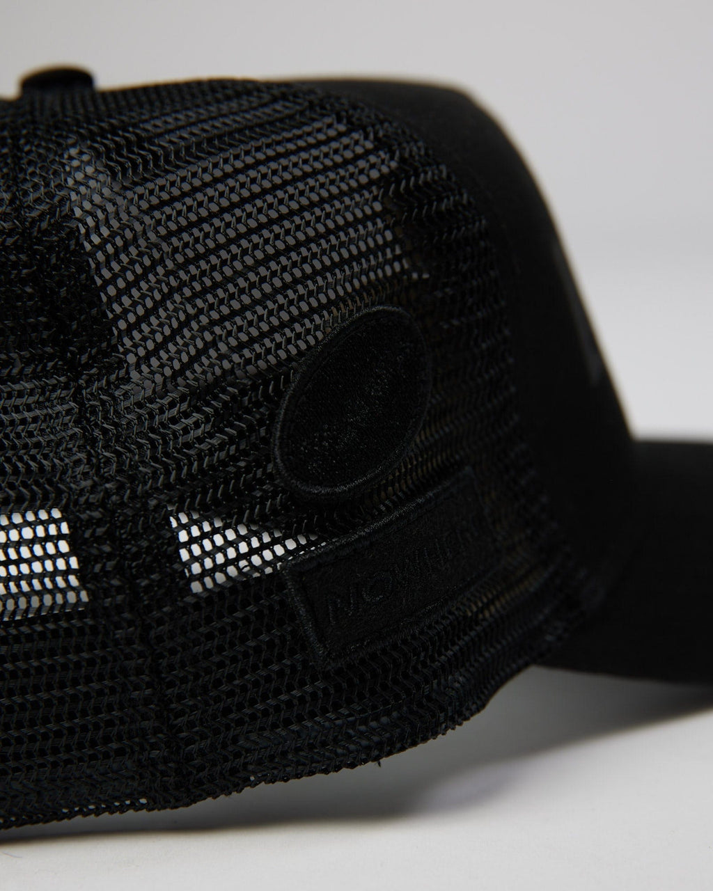 Model wearing TOBK Trucker Hat - Black