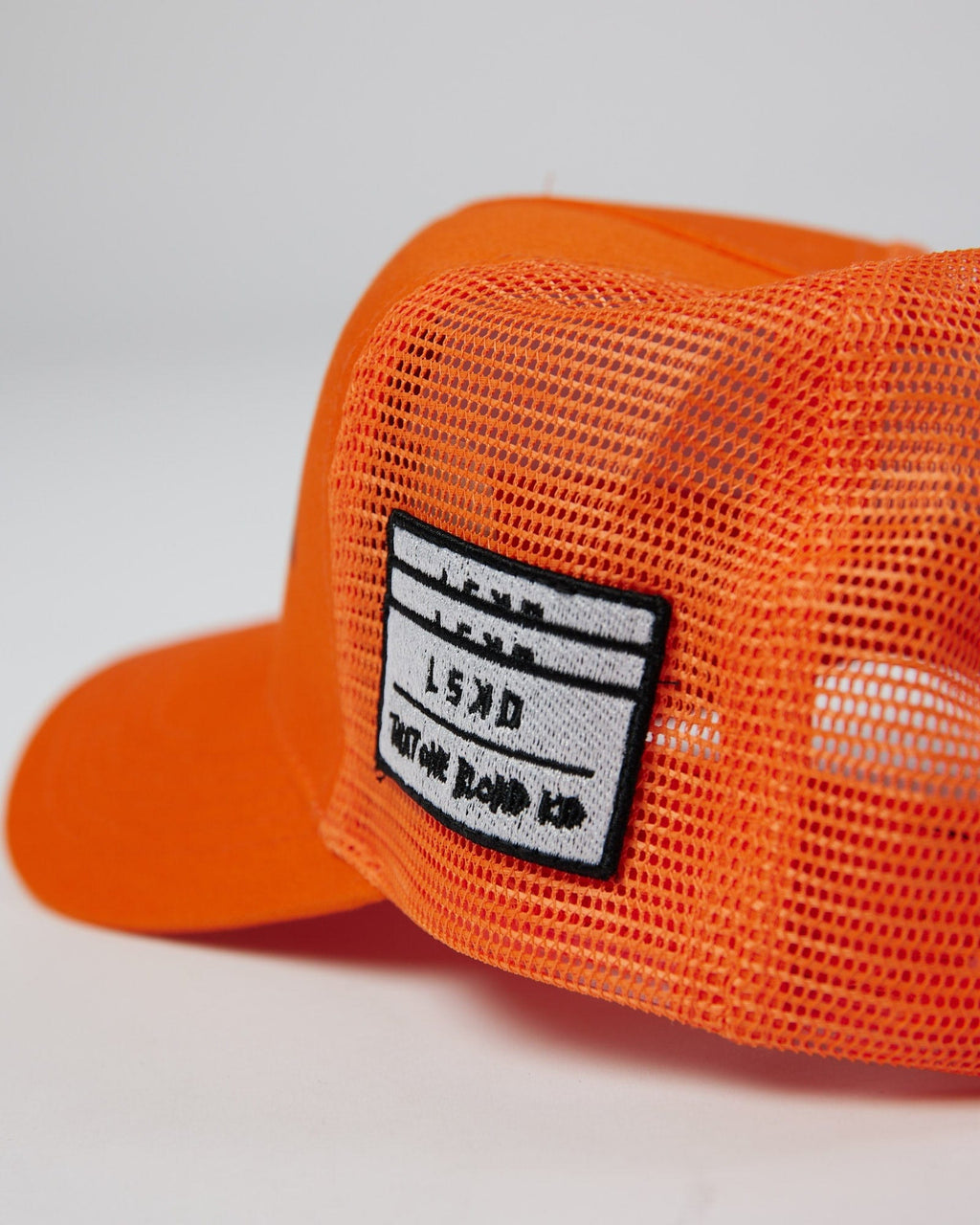 Model wearing TOBK Trucker Hat - Orange