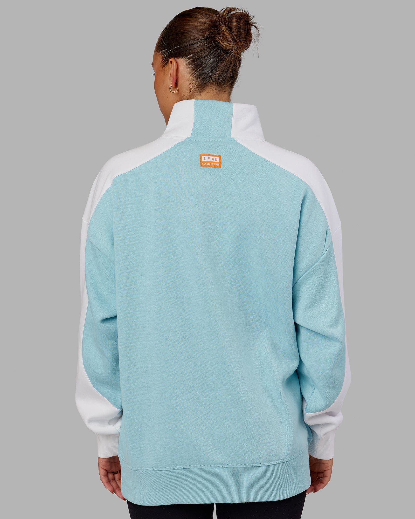 Model wearing Unisex Alumni 1/4 Zip Sweater Oversize - Crystal Blue-Orange Peel