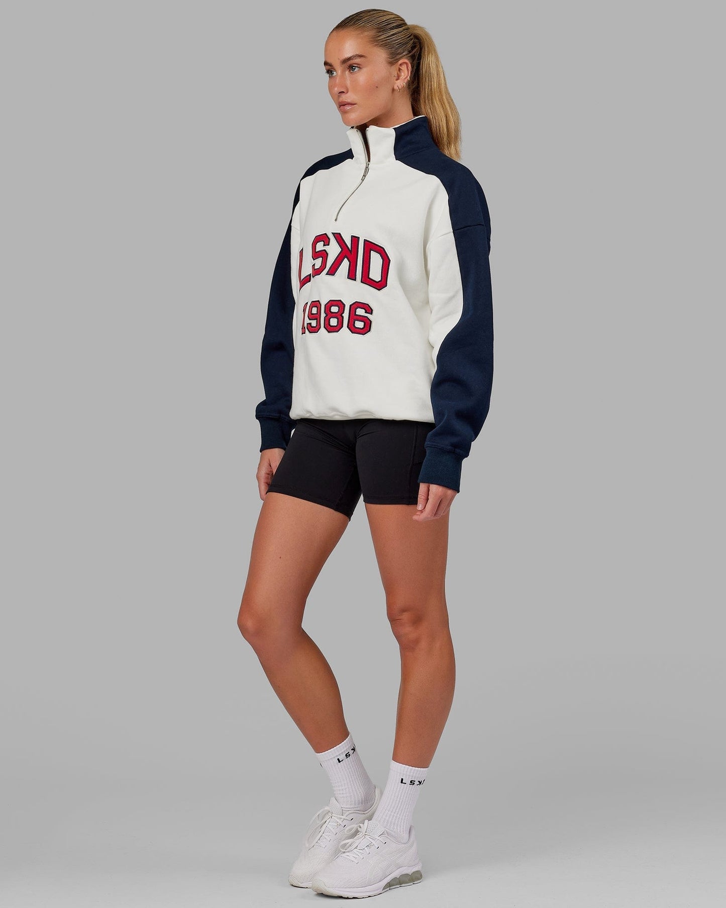 Model wearing Unisex Alumni 1/4 Zip Sweater Oversize - Navy-Red