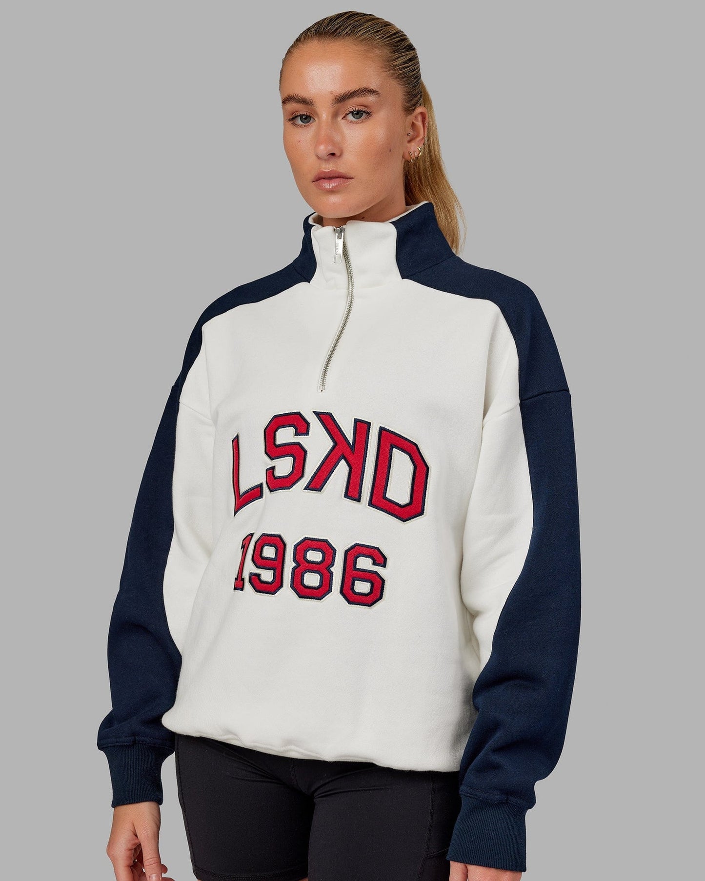 Model wearing Unisex Alumni 1/4 Zip Sweater Oversize - Navy-Red