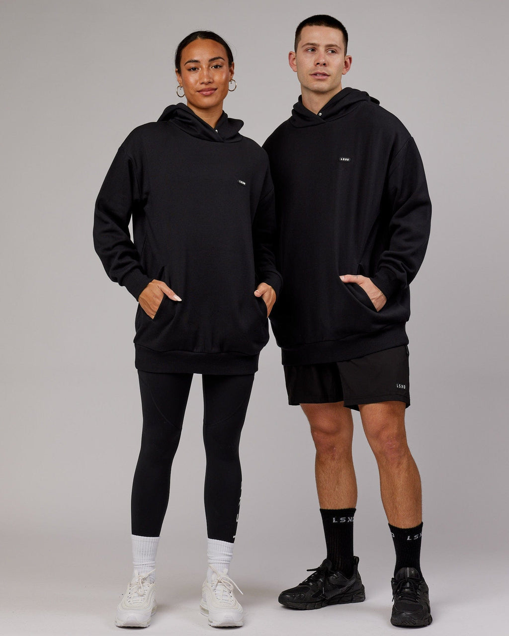 Model wearing Unisex Capsule Hoodie Oversize - Black