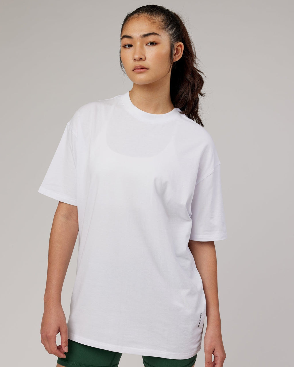 Model wearing Unisex DownLow FLXCotton Oversize Tee - White