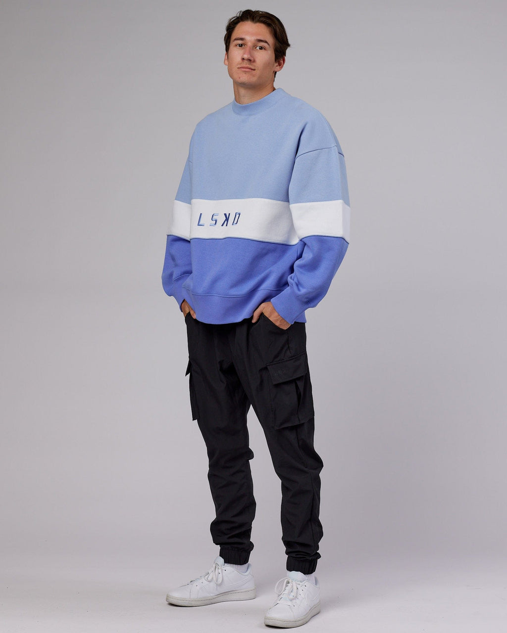 Model wearing Unisex Extra Time Sweater Oversize - Cornflower Blue-White