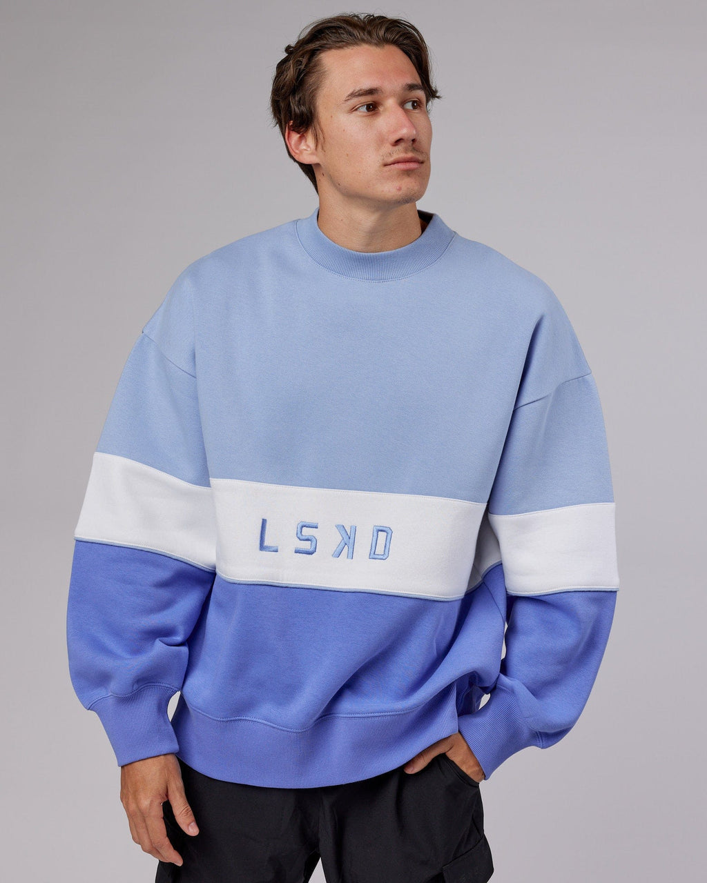 Model wearing Unisex Extra Time Sweater Oversize - Cornflower Blue-White
