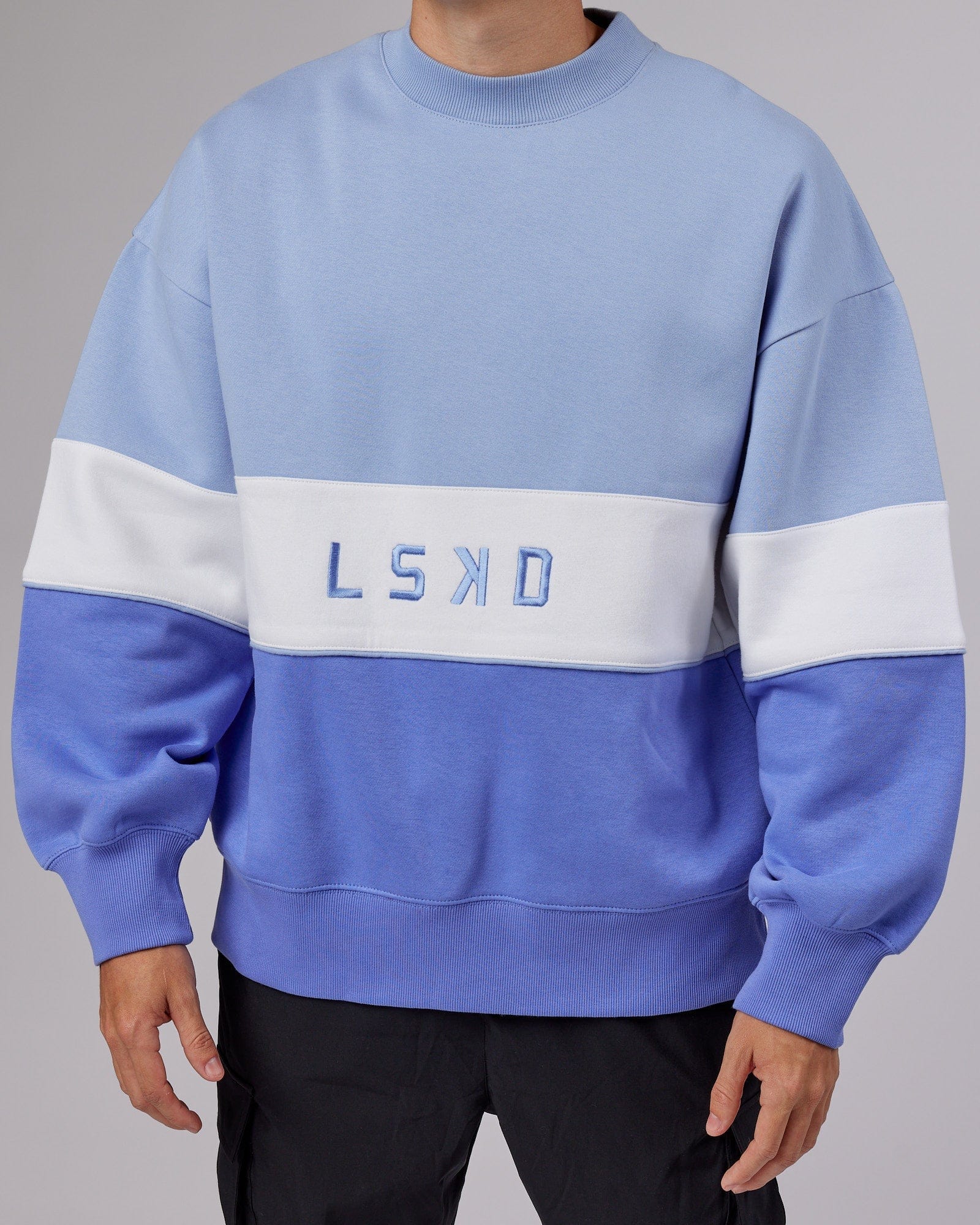 Model wearing Unisex Extra Time Sweater Oversize - Cornflower Blue-White