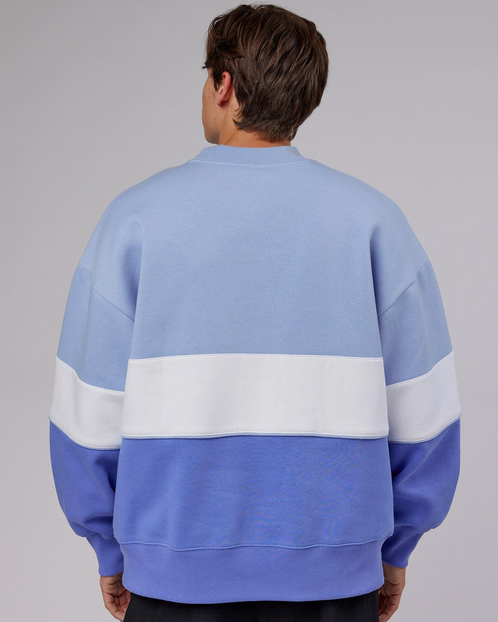 Model wearing Unisex Extra Time Sweater Oversize - Cornflower Blue-White