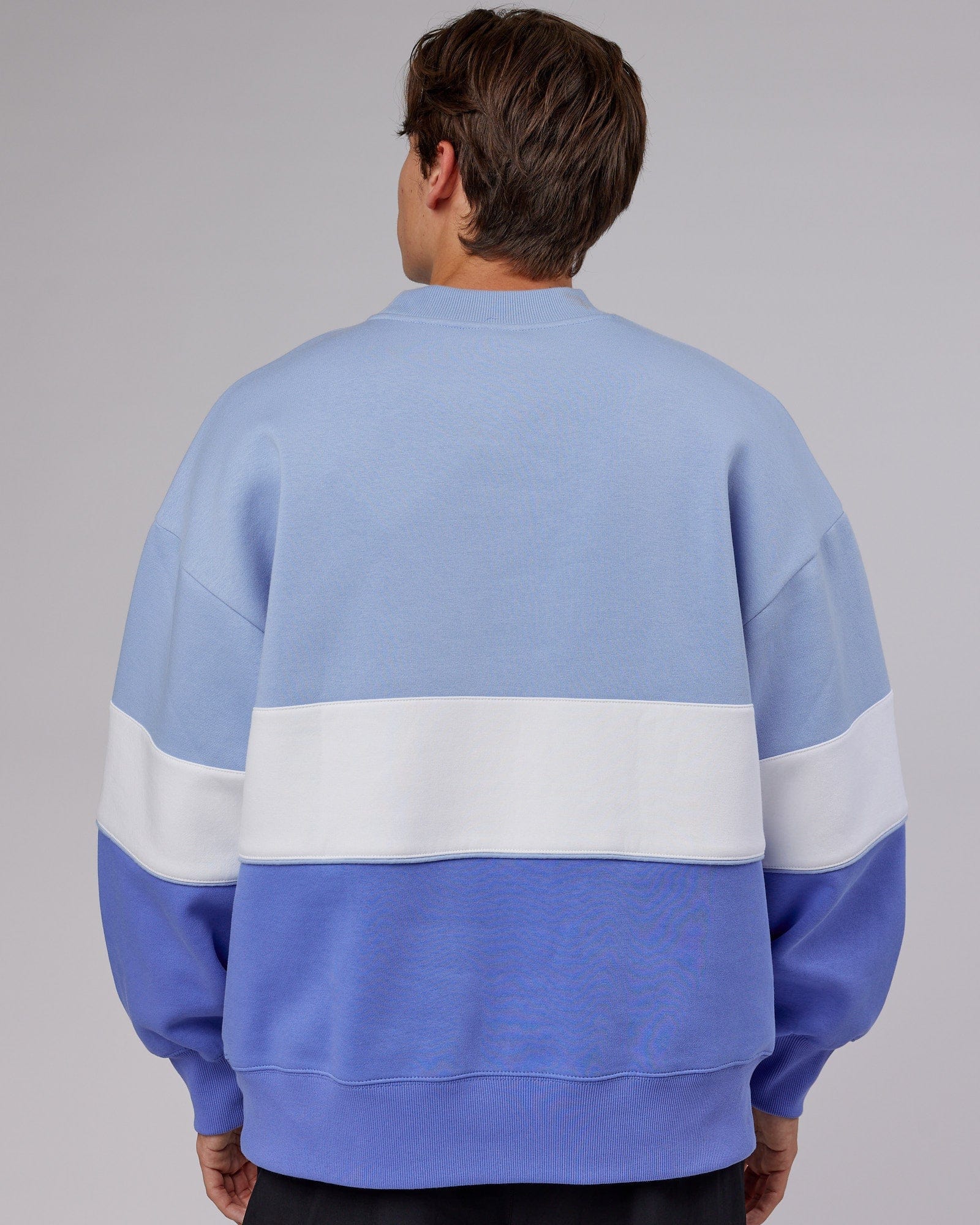 Model wearing Unisex Extra Time Sweater Oversize - Cornflower Blue-White