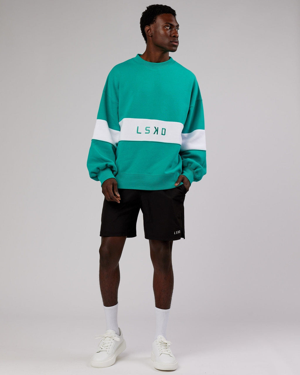 Model wearing Unisex Extra Time Sweater Oversize - Hyper Teal