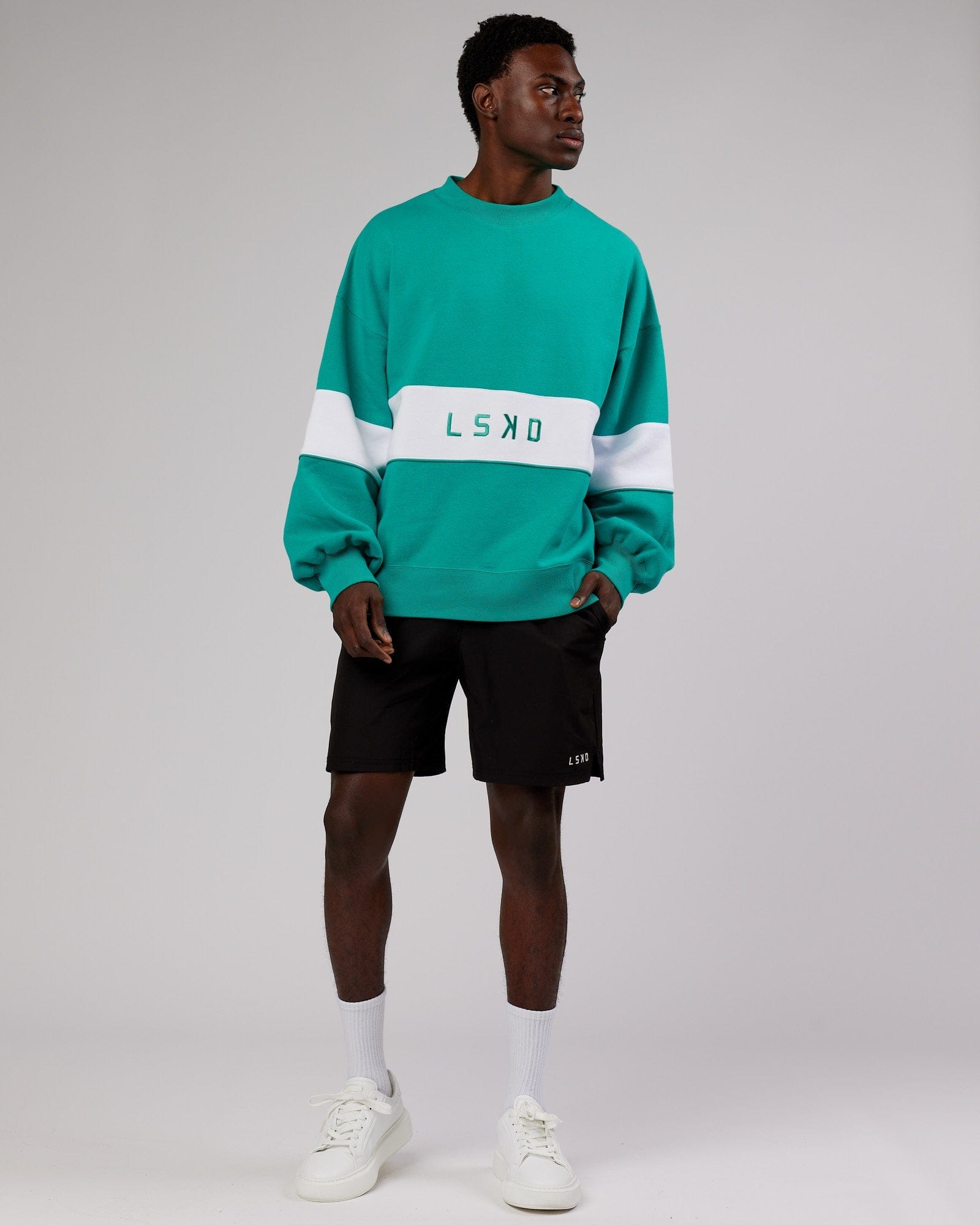 Model wearing Unisex Extra Time Sweater Oversize - Hyper Teal