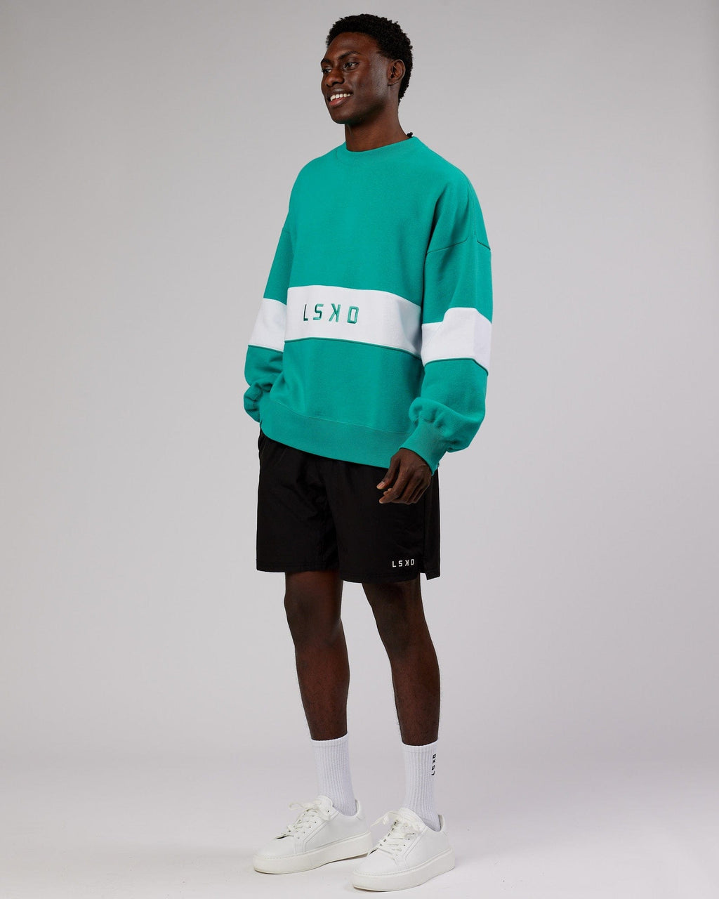 Model wearing Unisex Extra Time Sweater Oversize - Hyper Teal