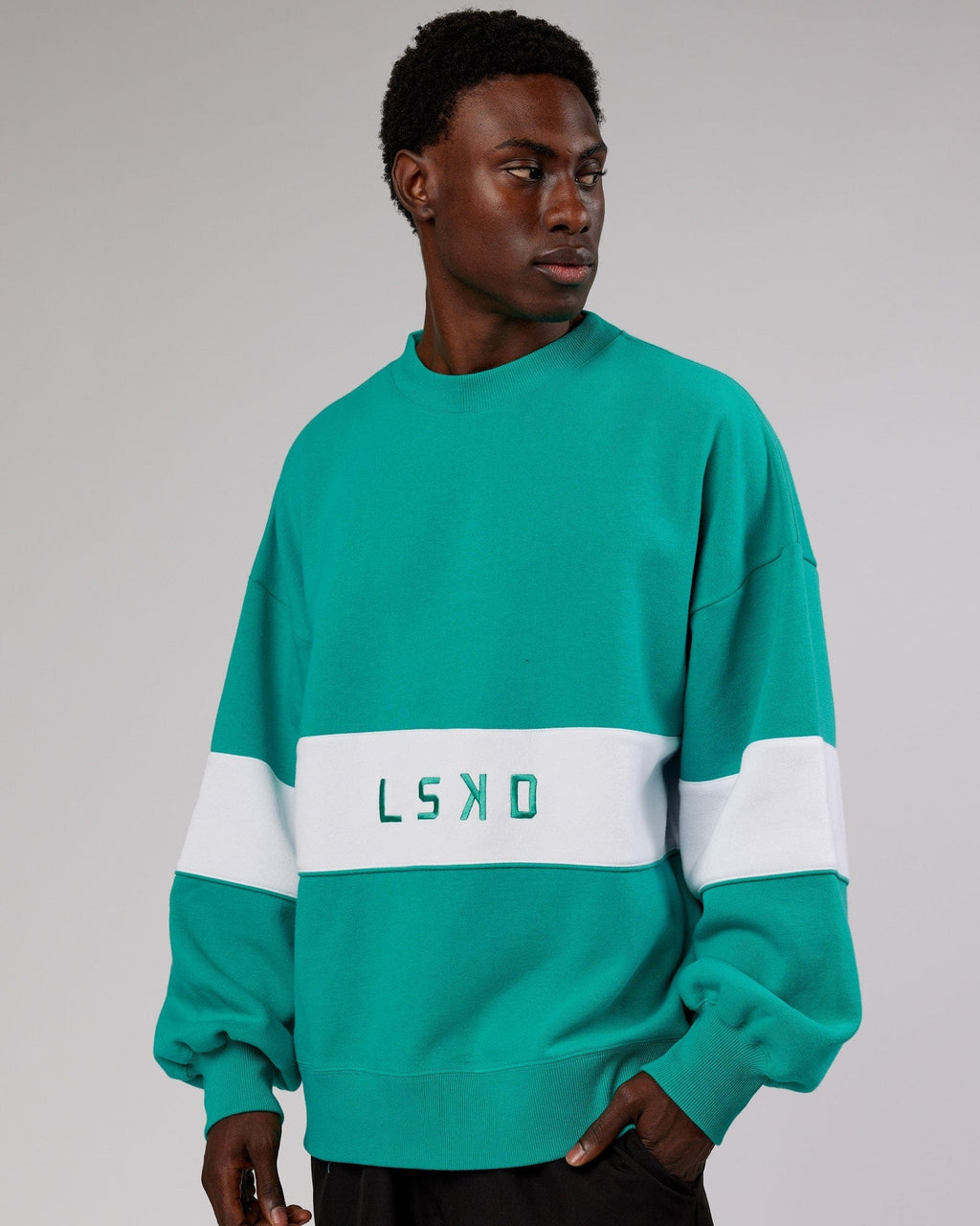 Model wearing Unisex Extra Time Sweater Oversize - Hyper Teal