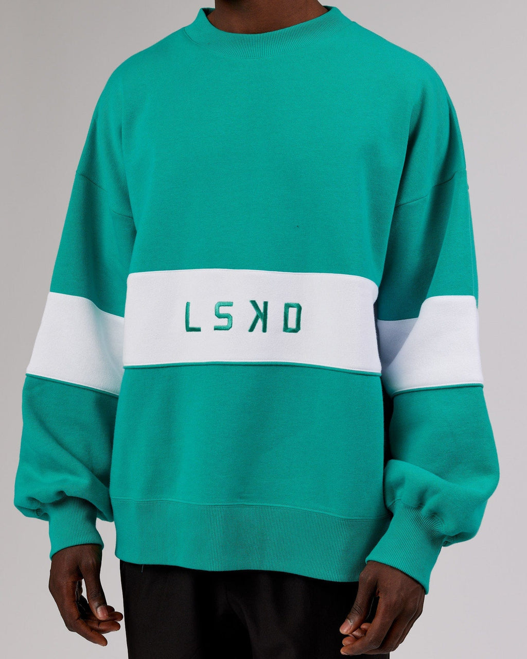 Model wearing Unisex Extra Time Sweater Oversize - Hyper Teal