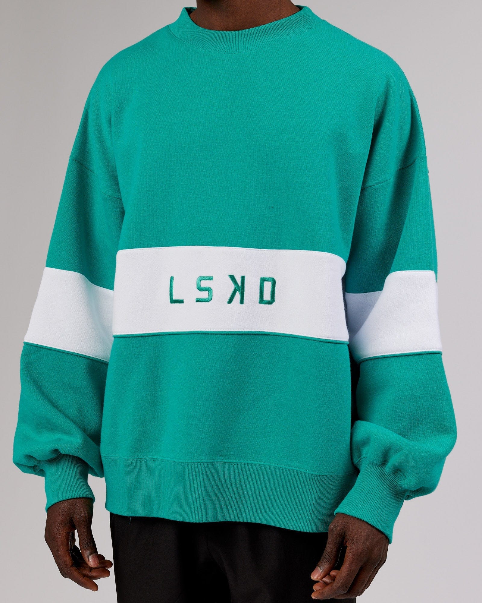 Model wearing Unisex Extra Time Sweater Oversize - Hyper Teal