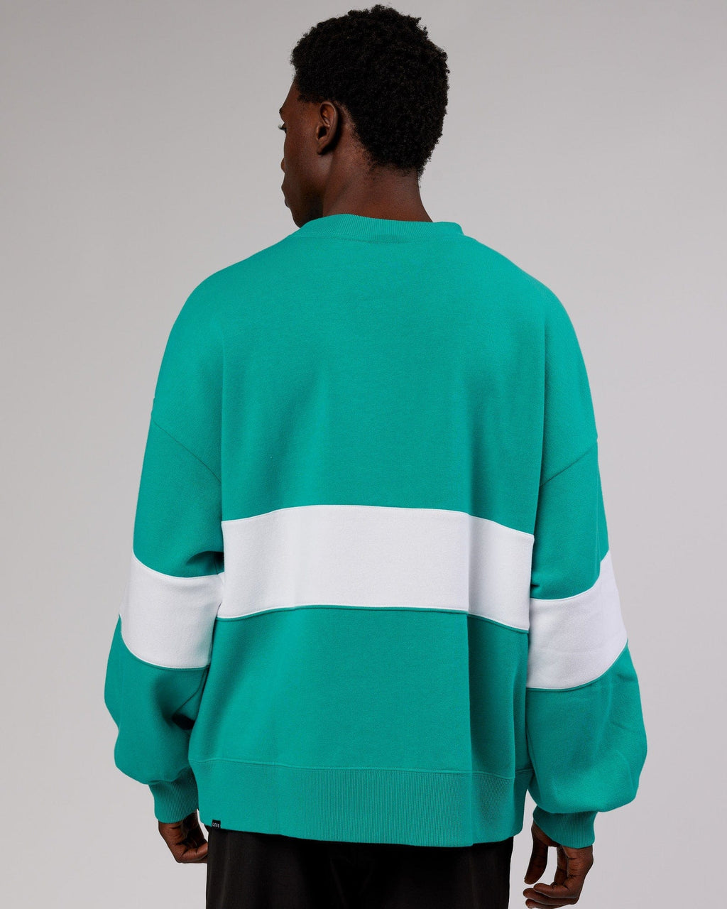 Model wearing Unisex Extra Time Sweater Oversize - Hyper Teal