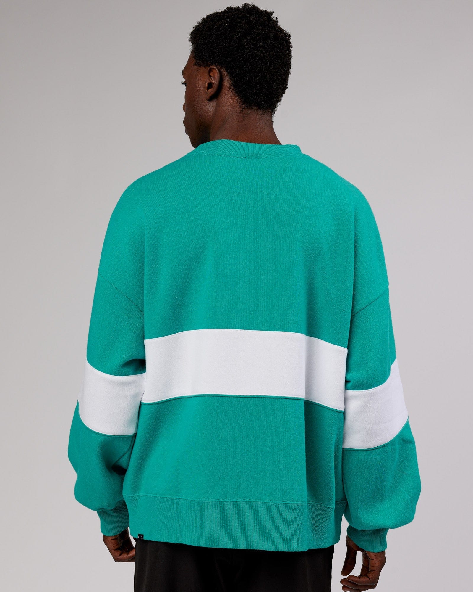 Model wearing Unisex Extra Time Sweater Oversize - Hyper Teal