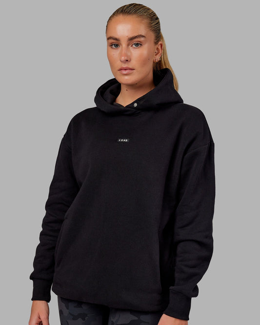 Model wearing Unisex Fundamental Hoodie Oversize - Black