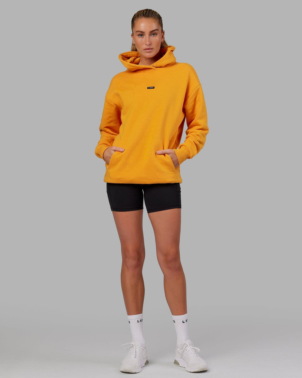 Model wearing Unisex Fundamental Hoodie Oversize - Butterscotch