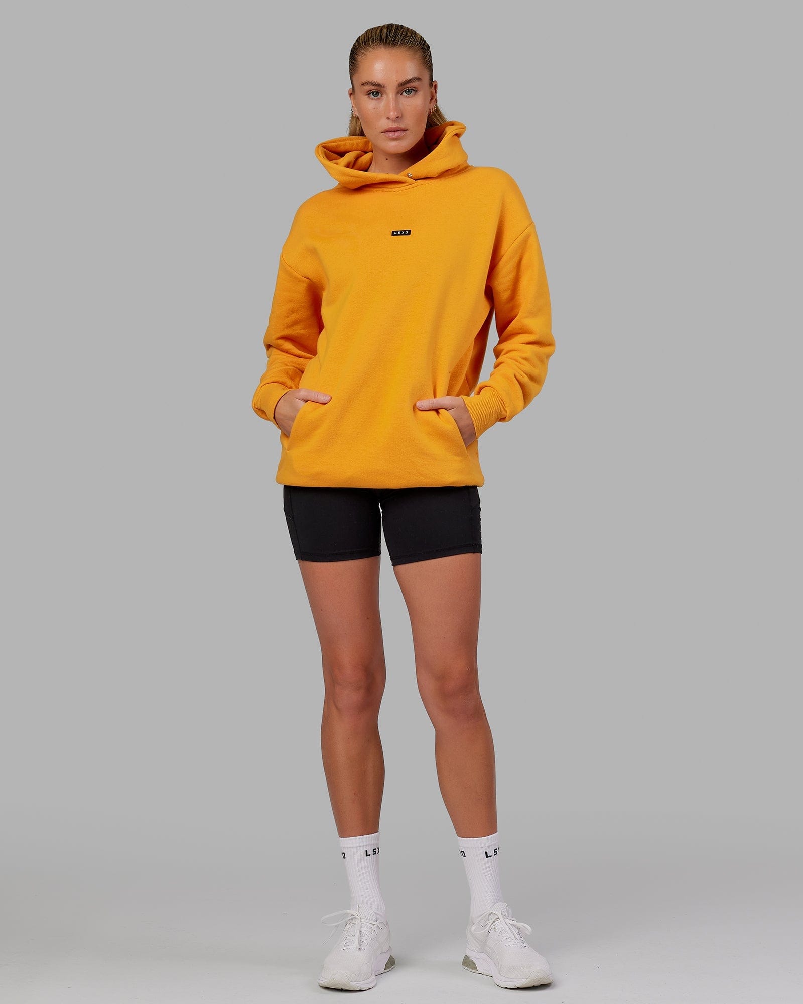 Model wearing Unisex Fundamental Hoodie Oversize - Butterscotch