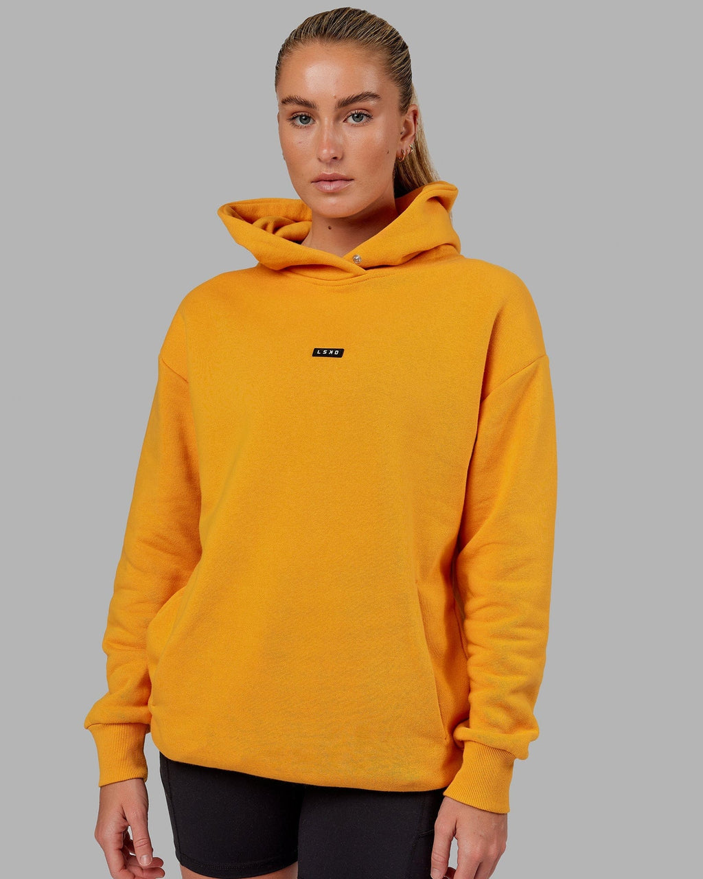 Model wearing Unisex Fundamental Hoodie Oversize - Butterscotch