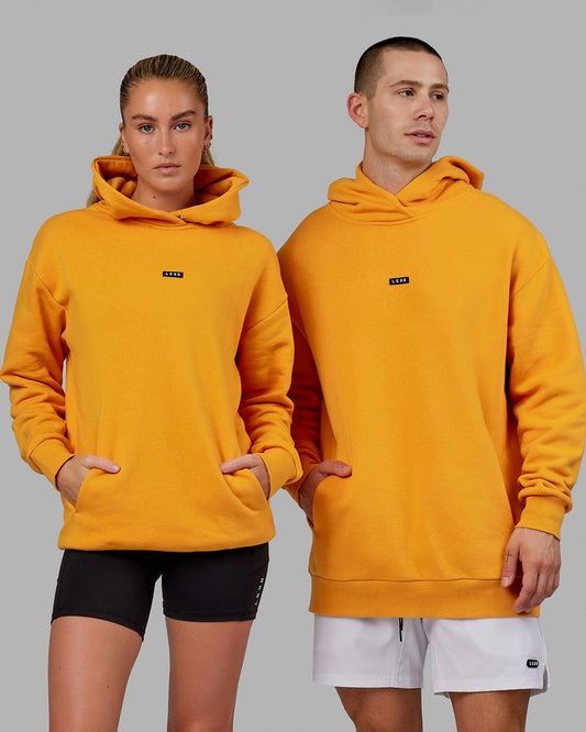 Model wearing Unisex Fundamental Hoodie Oversize - Butterscotch