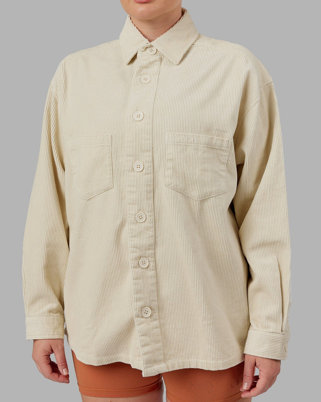 Model wearing Unisex Iconic Cord Shacket - Bone