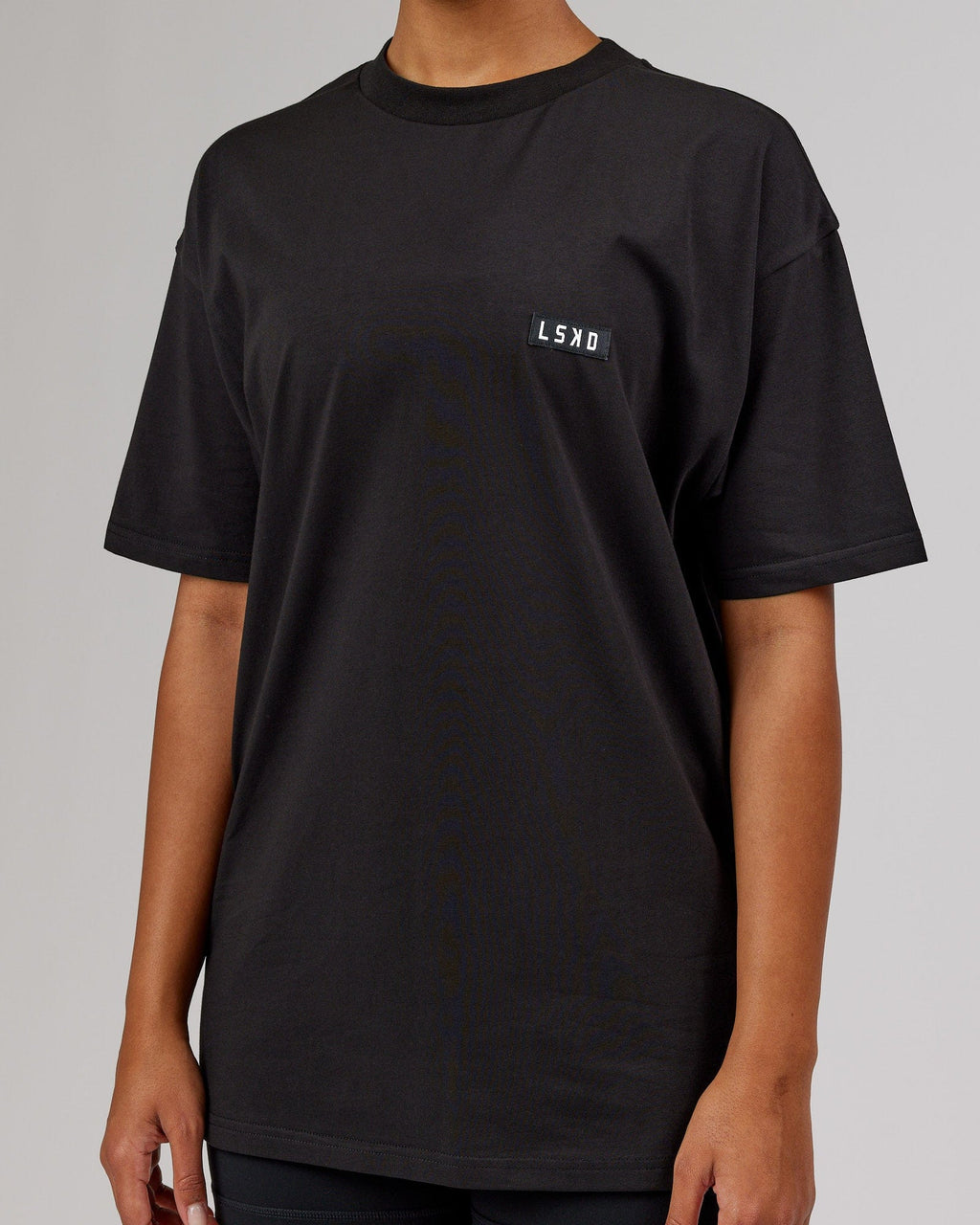 Model wearing Unisex Iconic FLXCotton Tee Oversize - Black-White