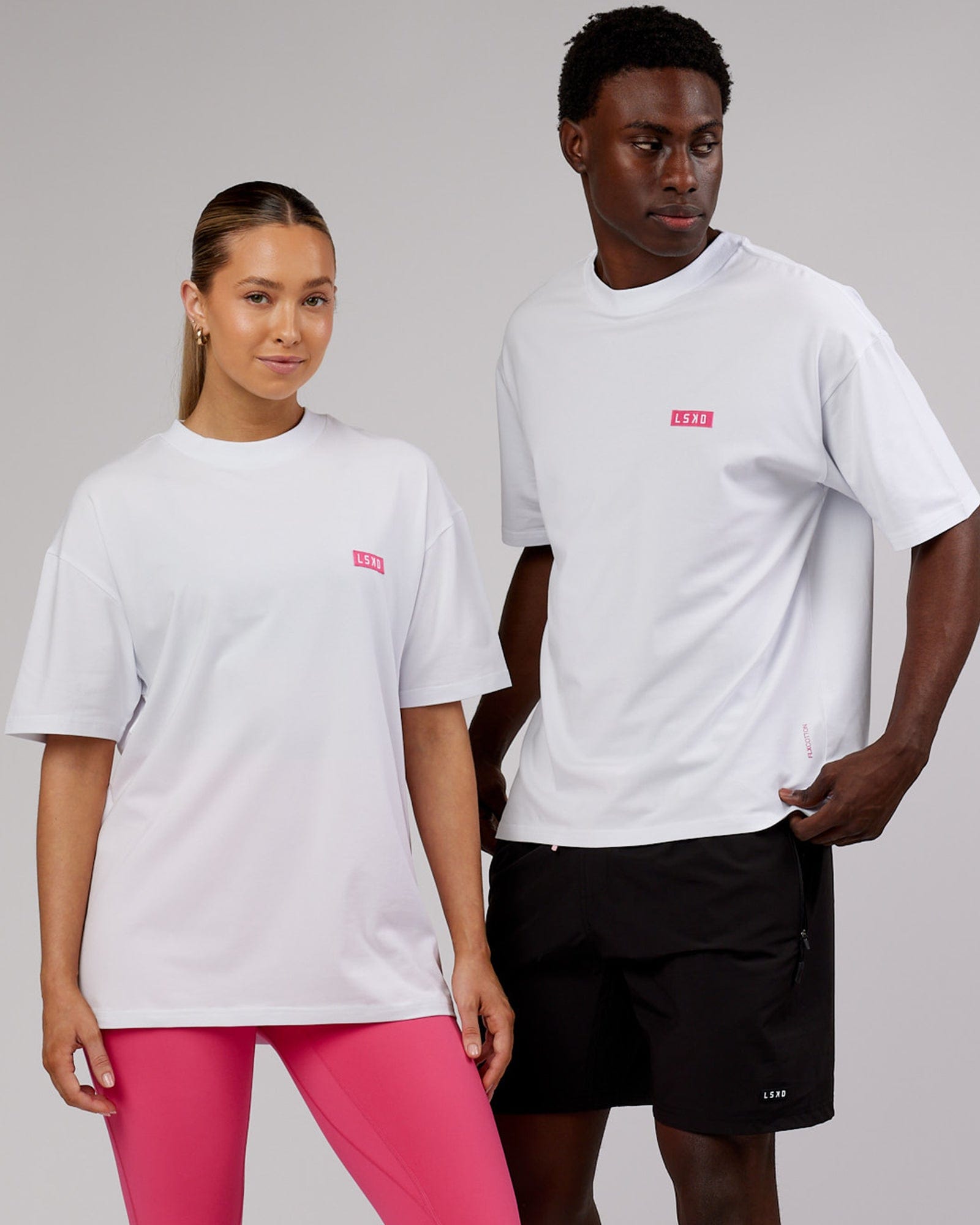 Model wearing Unisex Iconic FLXCotton Tee Oversize - White-Pink
