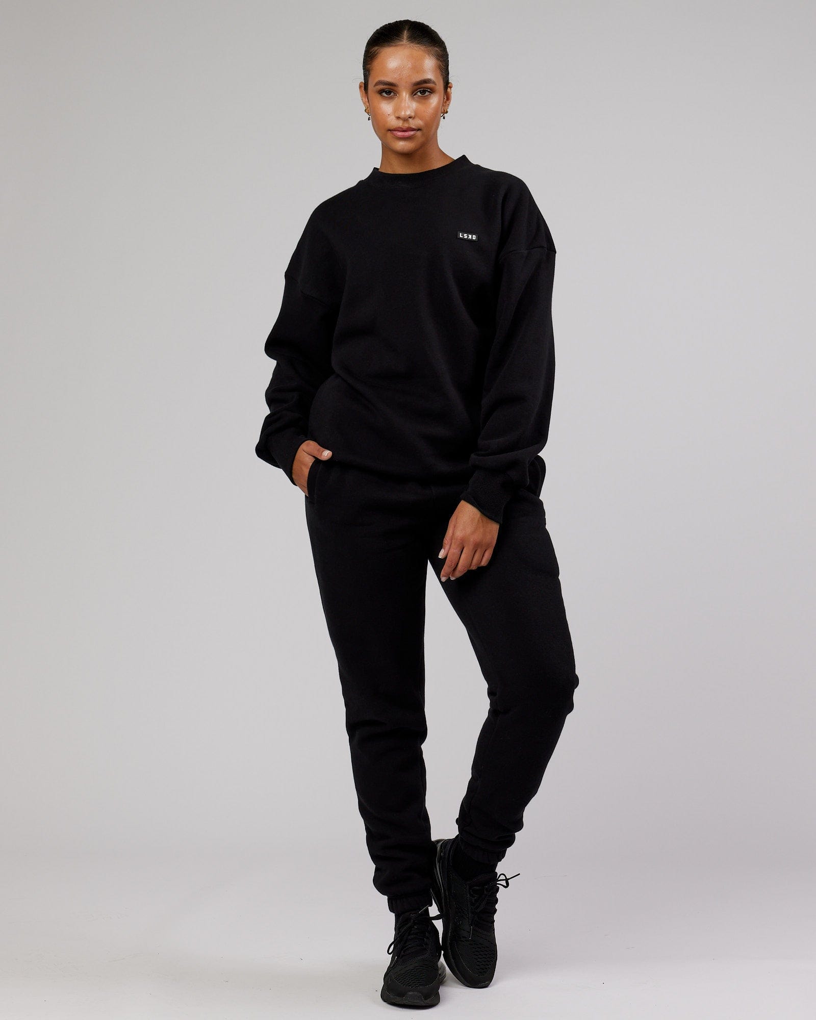 Model wearing Unisex Iconic Track Pant - Black
