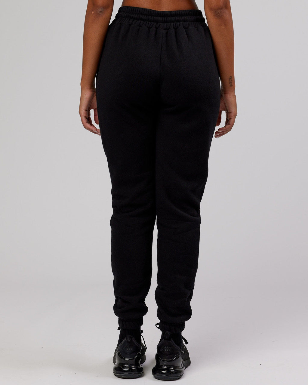 Model wearing Unisex Iconic Track Pant - Black