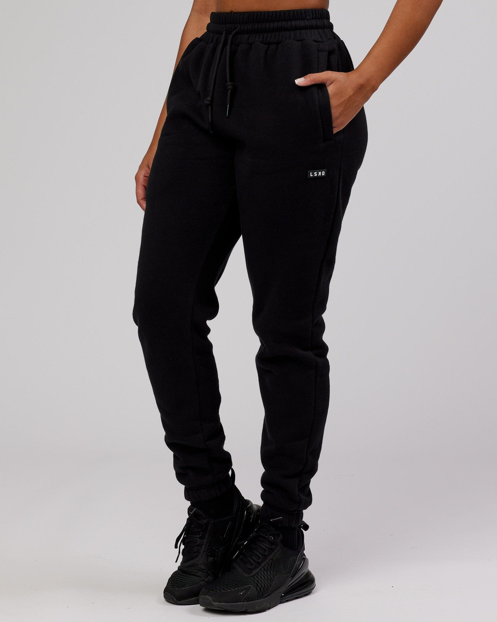 Model wearing Unisex Iconic Track Pant - Black