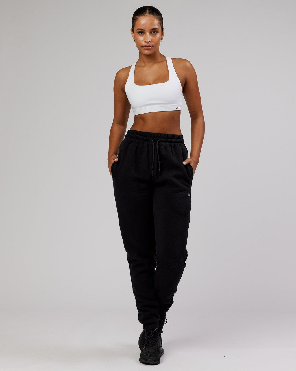 Model wearing Unisex Iconic Track Pant - Black